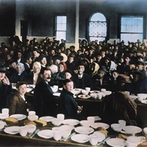IMMIGRANTS: ELLIS ISLAND. In the dining hall: oil over a photograph, c1900