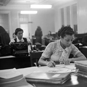 INSURANCE COMPANY, 1941. Employees at work at an African American insurance company in Chicago