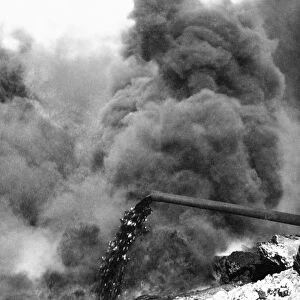 IRAQ: OIL WELL FIRE, c1932. Clouds of smoke from an oil well fire in the Kirkuk district of Iraq