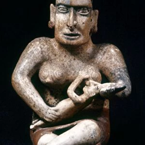 JALISCO: MATERNITY FIGURE. Pre-Columbian ceramic maternity figure nursing her child, from Jalisco, Mexico