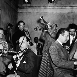 JAM SESSION, 1947. Jam session at a Hollywood studio: Les Paul, guitar; Joe Venuti, violin, Wingy Manone, trumpet; Candy Candido, bass; Jess Stacy, piano; Jerry Wald, clarinet; Abe Lyman, drums. Photographed in March 1947
