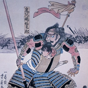 JAPAN: SAMURAI. Samurai warrior on his shield, holding the head of one of his victims