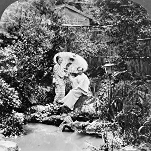 JAPAN: TEA GARDEN, c1906. A Japanese woman and a western man in a tea garden in Japan