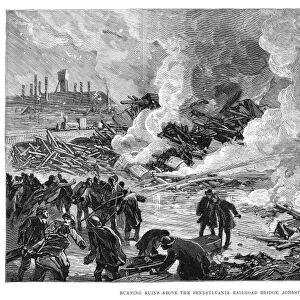 JOHNSTOWN FLOOD, 1889. Burning ruins above the Pennsylvania Railroad Bridge, Johnstown