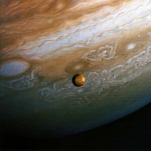 JUPITER. View of Jupiter and its moon Io from 8 million miles. Photographed by the Voyager 2, 25 June 1979