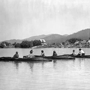 KALISPEL TRIBE, c1910. Native Americans in three canoes with their camp on the