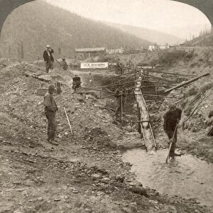 KLONDIKE GOLD RUSH. Miners working at a sluice box in Alaska. Stereograph view, c1898
