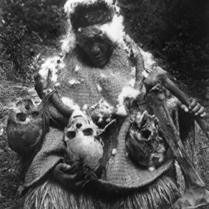 KWAKIUTL DANCER, c1911. A Kwakiutl Native American dancer in ceremonial costume with human skulls