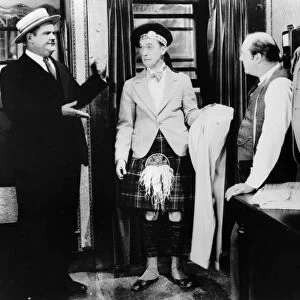 LAUREL AND HARDY, 1927. Stan Laurel (center) and Oliver Hardy (left) in a scene from Putting Pants on Philip, their first film as a comedy duo, 1927, directed by Hal Roach