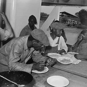 LOUISIANA: STEVEDORES, 1938. Stevedores eating on the stern of the boat El Rito in Pilottown