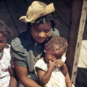 LOUISINA: GIRLS, 1940. Three African American girls sitting on the porch of a cooperative