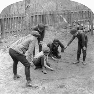 MARBLE GAME, c1891. Boys playing marbles. Stereograph, c1891