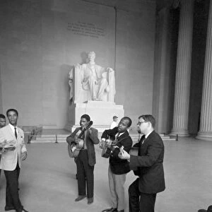 MARCH ON WASHINGTON, 1963. Men singing and playing guitars inside the Lincoln Memorial