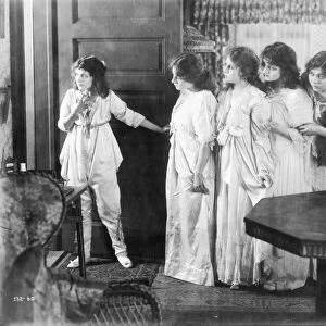 Marguerite Clark and other cast members in a scene from the silent film, 1916; American