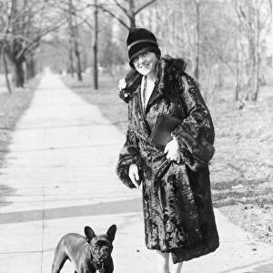MARY ROBERTS RINEHART (1876-1958). American novelist and playwright. Photographed with her pet bulldog, early 20th century