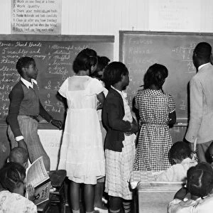 MARYLAND: CLASSROOM, 1940. A teacher explaining decimals to seventh grade students