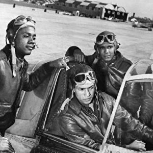 Members of the first group of African American pilots in the history of the U. S. Army Air Corps, identified standing left to right: Hicks, Clifton and Moody, with Williams at the control. Photograph, c1942