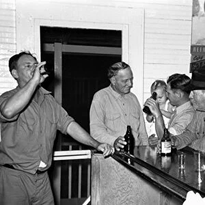 Men drinking beer at the bar in Pilottown, Louisiana. Photograph by Russell Lee, September 1938