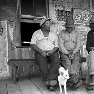 MEN TALKING, 1938. African American men talking on a porch of small rural store near Jeanerette