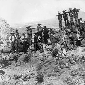 MEXICAN REVOLUTION, 1911. Mexican revolutionary troops aiming rifles from a mountain position
