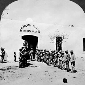 MEXICAN REVOLUTION, 1914. Armed revolutionary troops lined up outside the entrance