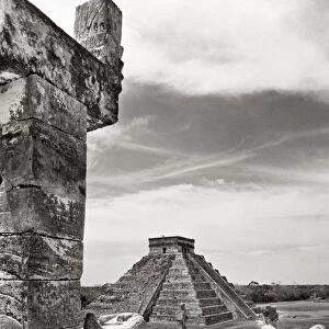 MEXICO: CHICHEN ITZA, View from a serpent column past a Chac-mool statue to the Castillo pyramid at the Mayan ruins of Chichen Itza on the Yucatan Peninsula. Mexico. Photograph, c1970s