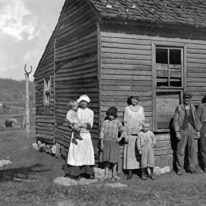 MIGRANT FAMILY, 1916. The Hazel family posing in front of their dilapidated farmhouse