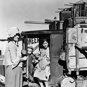MIGRANT FAMILY, 1935. Drought refugees from Oklahoma looking for work in the pea
