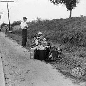 MIGRANT FAMILY, 1937. A family hitchhiking along the highway in Macon, Georgia