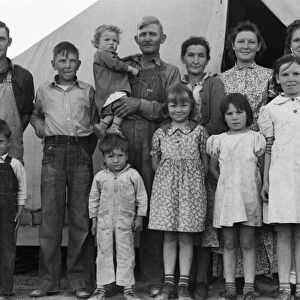 MIGRANT FAMILY, 1939. An ex-tenant farmer from Oklahoma with his wife and ten children