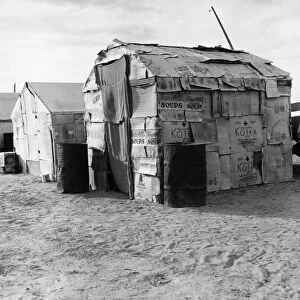 MIGRANT FARMER CAMP, 1938. Camp of cardboard houses inhabited by migrant farmers in America