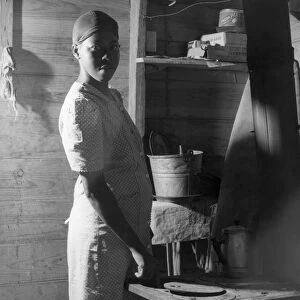MIGRANT WORKER, 1940. A migrant worker in the windowless cabin where she lives