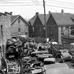 MILWAUKEE: AUTO PARTS, 1936. A junkyard with auto parts and scrap metal alongside