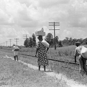 MISSISSIPPI: NATCHEZ, 1940. A family walking along the railroad tracks in Natchez, Mississippi