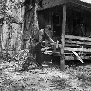MISSOURI: SHARECROPPER. A sharecropper splitting hickory for chair-bottoms in the Ozark Mountains