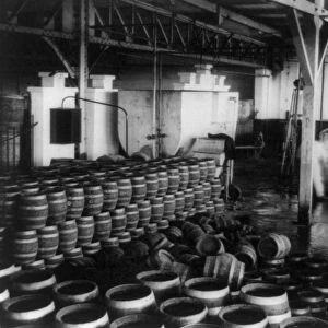 MOONSHINE, 1920s. Barrels of moonshine whiskey inside a warehouse during Prohibition in America