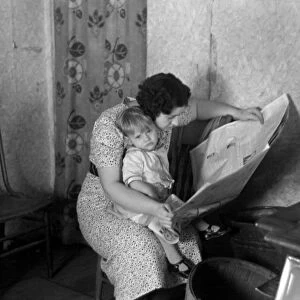 MOTHER AND CHILD, 1936. A mother and child in their shack near Dickens, Iowa