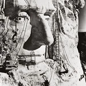 MOUNT RUSHMORE, 1936. Workers sculpting the face of Abraham Lincoln during the construction of Mount Rushmore, South Dakota, 1936