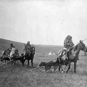 MOVING CAMP, c1908. Gros Ventre people moving camp with horses and travois in Montana