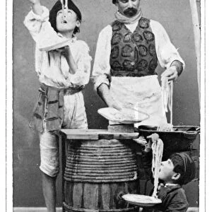 NAPLES: PEASANT, 1869. A man and two boys, peasants of Naples, Italy, eating macaroni