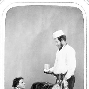 NAPLES: PEASANT, 1869. A pair of peasants from Naples, Italy milking a goat. Photograph