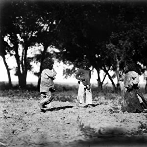 NAVAJO CHILDREN, c1905. Three Navajo children playing, with cottonwood trees in the background