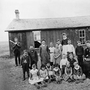 NEBRASKA: SCHOOLHOUSE. A teacher and students outside of a schoolhouse in Nebraska