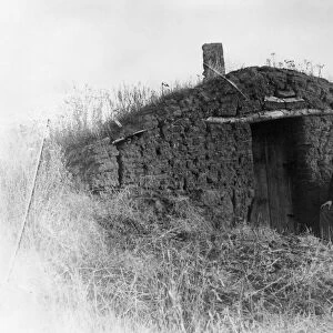 NEBRASKA: SETTLERS, 1892. A homesteader in front of his sod house near Roten Valley