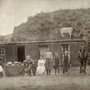 NEBRASKA: SETTLERS, c1886. A pioneer family photographed outside of their sod house at Sargent, Custer County, Nebraska. Photograph by Solomon D. Butcher, c1886