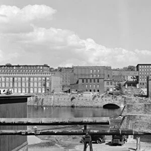 NEW HAMPSHIRE, 1936. View of the Amoskeag mills and remains of the bridge in Manchester