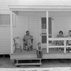 NEW HOME, 1938. Former tenant farmer and family on the front porch of their new home, Missouri