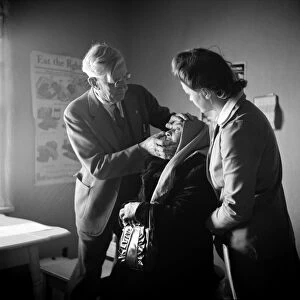 NEW MEXICO: HEALTH CLINIC. Dr. Werner Onstine examining a patient at a clinic operated