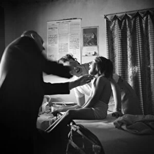 NEW MEXICO: HEALTH CLINIC. A girl being examined in a clinic operated by the Taos