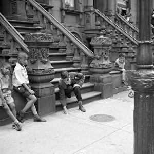 NEW YORK CITY, 1938. Boys playing on a stoop in Harlem, New York City. Photograph by Jack Allison
